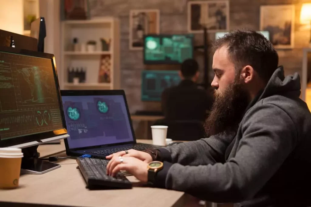 Ethical hacker analyzing system security on a laptop.